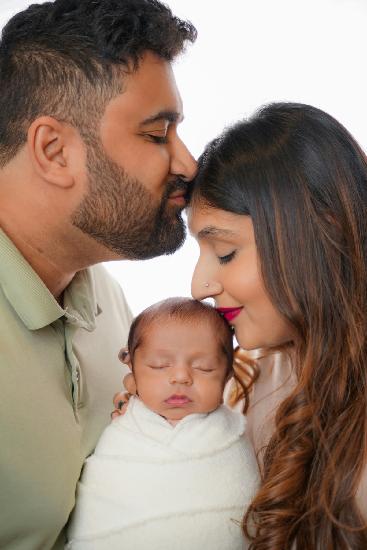 Parents holding their newborn baby during CPR and AED training